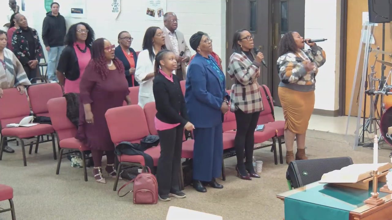 The congregation stands and sings with the praise team
